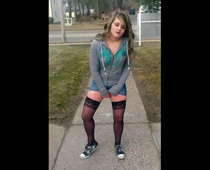 Young in tights and sneakers romps herself in the street.